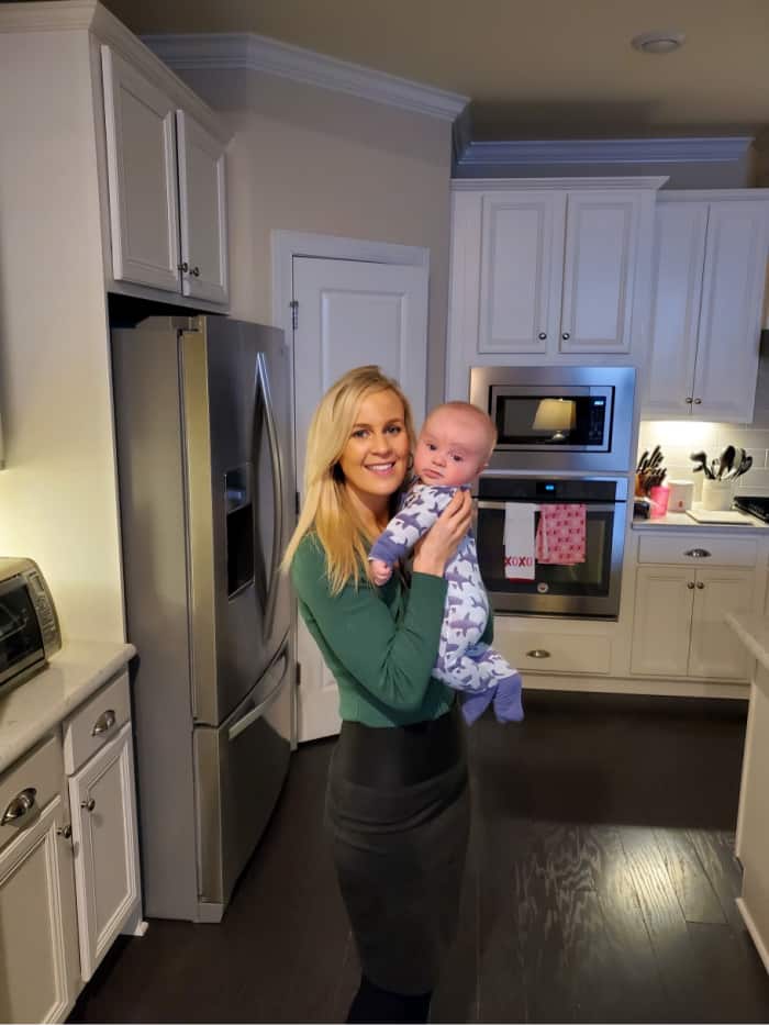 Lindsey hugging Jacob in the kitchen before work