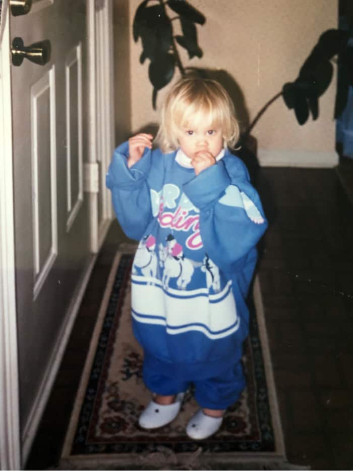 Lindsey in a giant sweater as a toddler