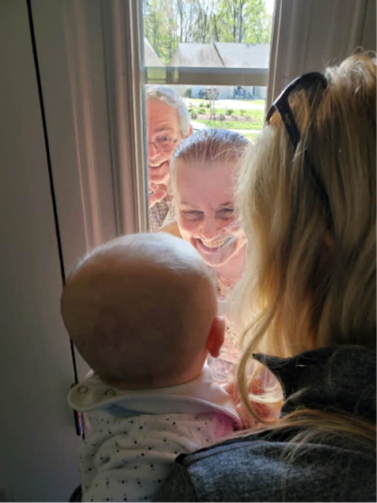 Jacob looking at his grandparents through the front door window