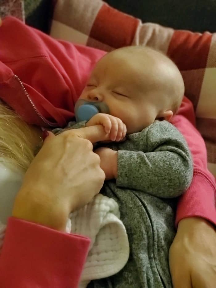 Jacob holding Lindsey's hand while sleeping