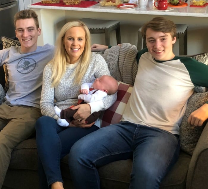 Lindsey, Jacob, and Lindsey's nephews sitting on the couch at home