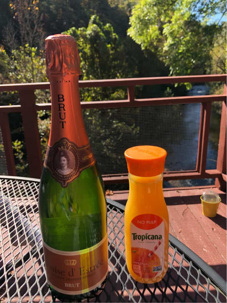 A bottle of champagne and orange juice on the balcony