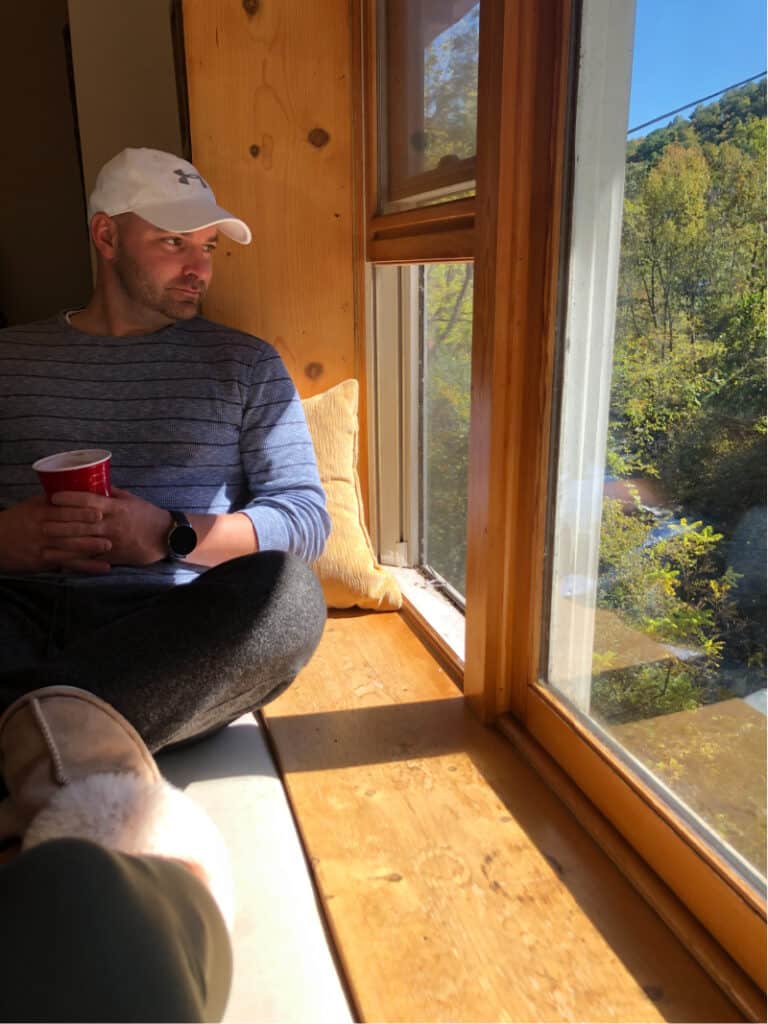 Joey sitting on the window ledge looking out at the creek