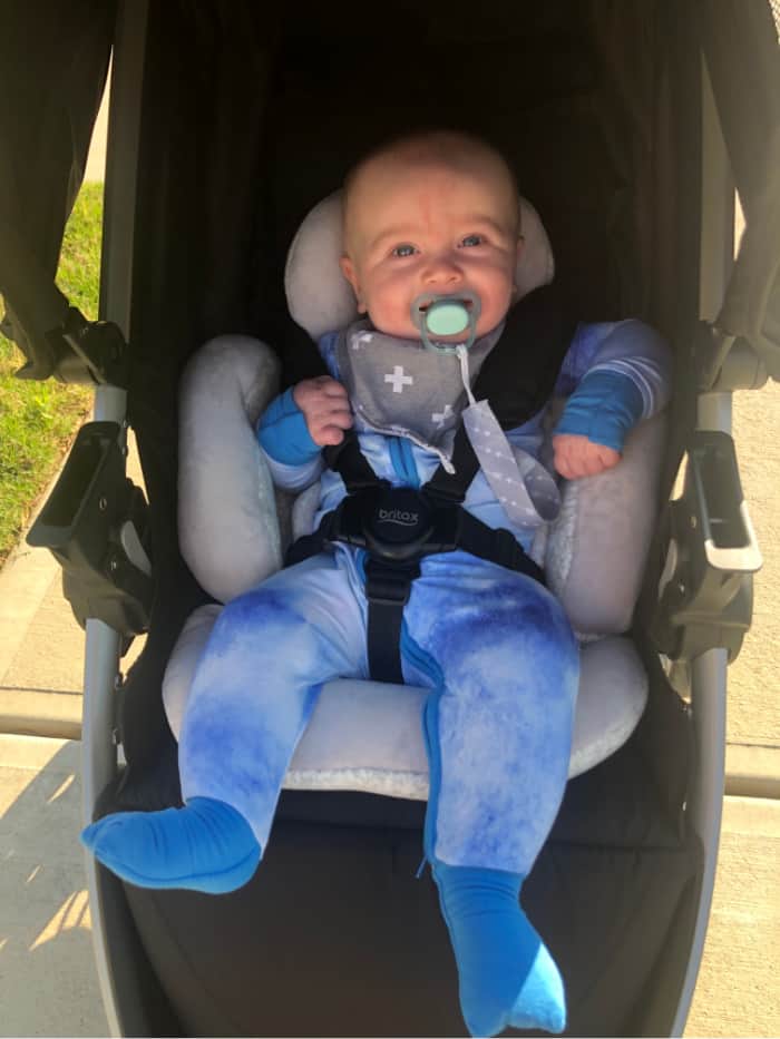 Jacob in his blue zip pajamas in the stroller.