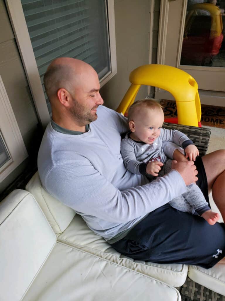 Joey holding a happy Jacob on the patio