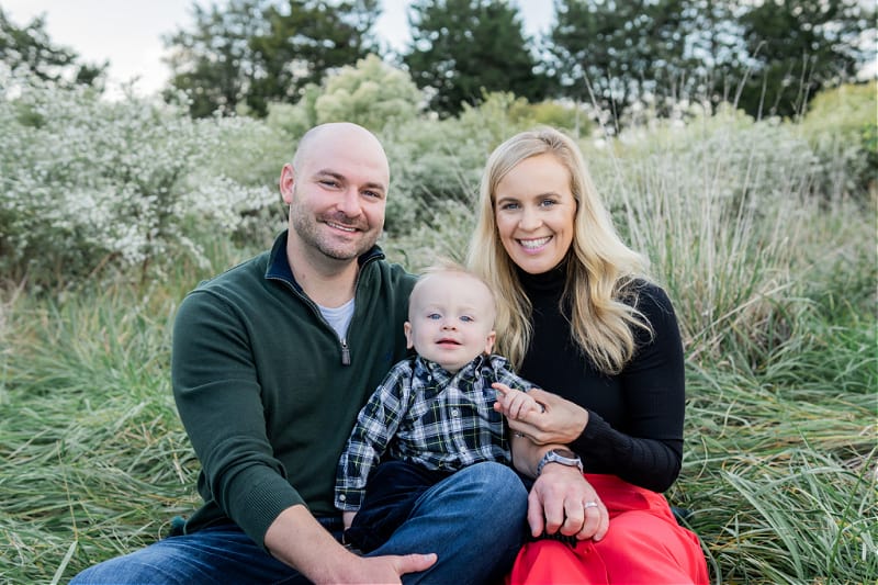 Joey, Lindsey & Jacob family picture sitting in a green field