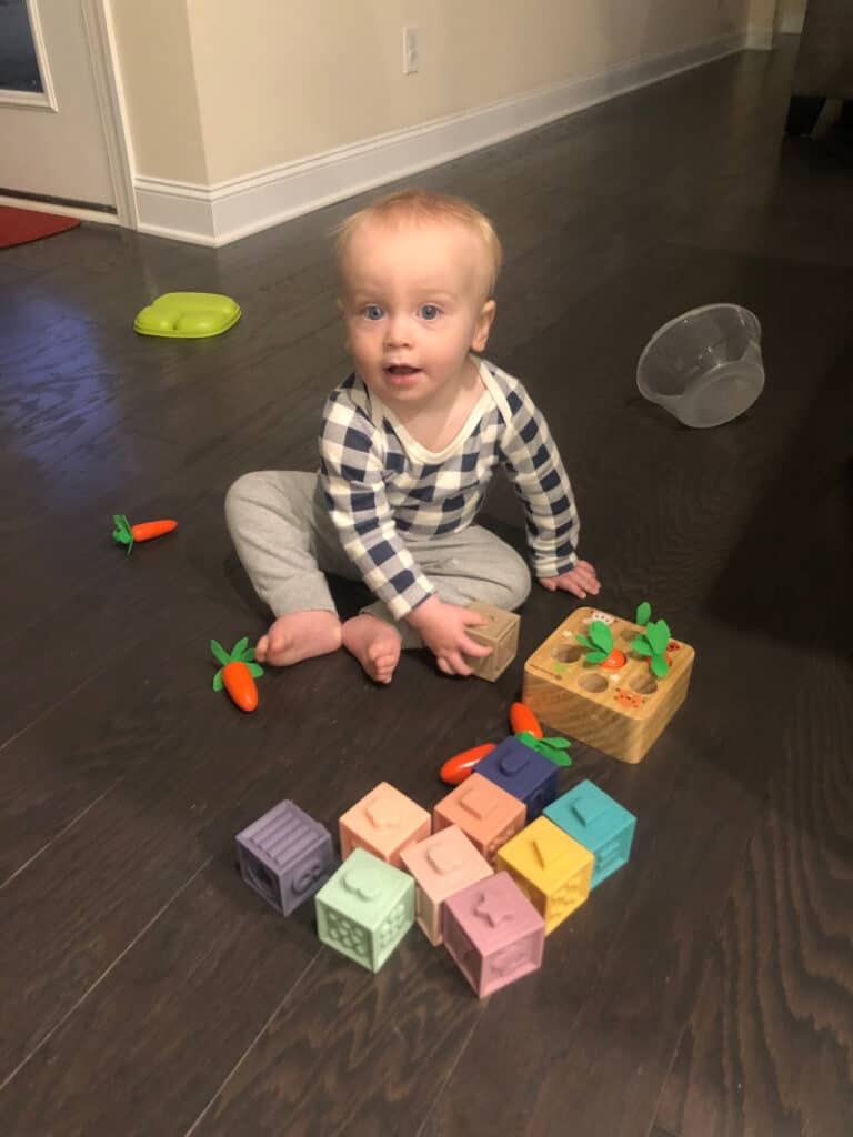 Jacob playing with toys on the kitchen floor