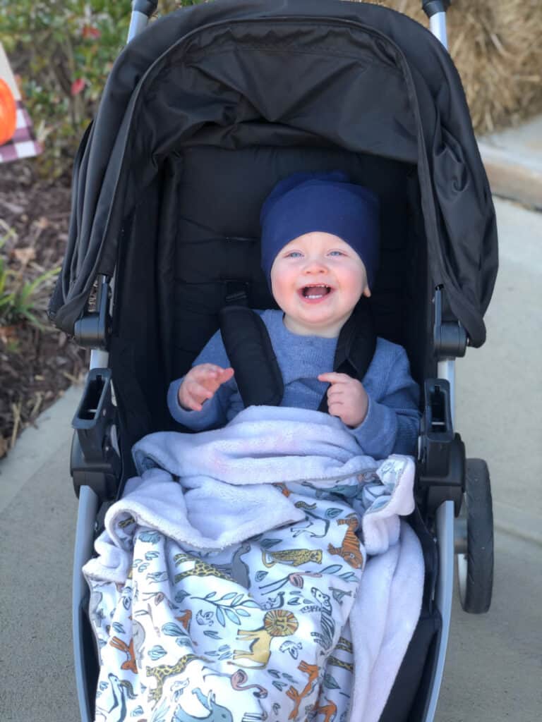 Jacob smiling in the stroller. 