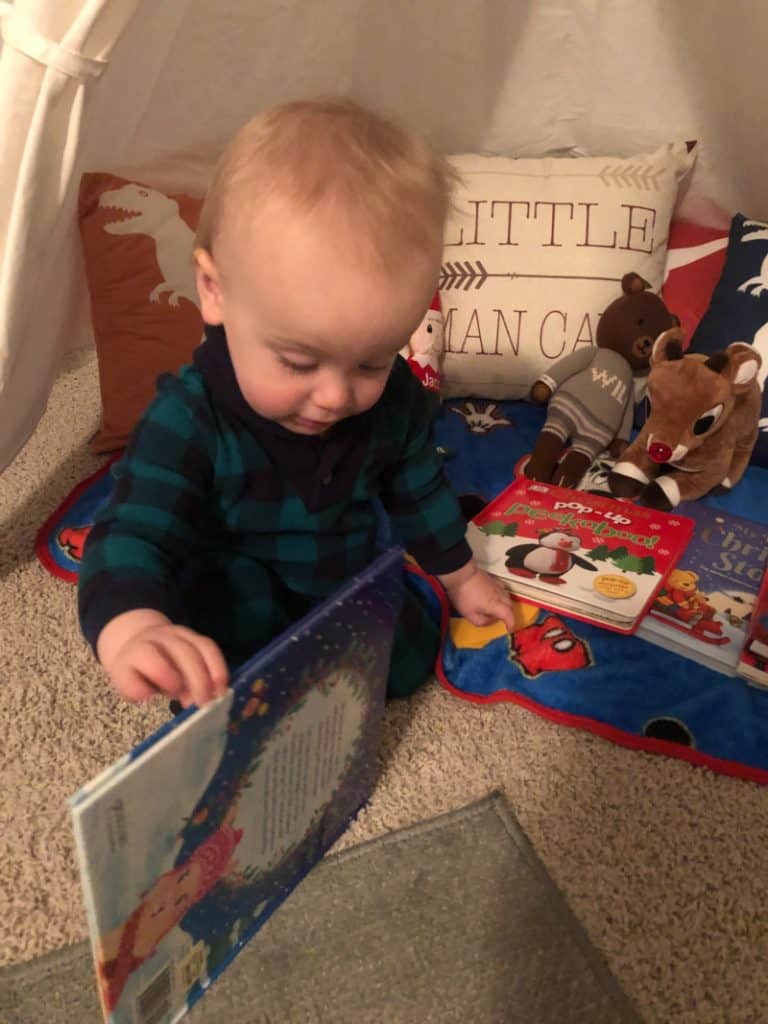 Jacob opening a Christmas book.