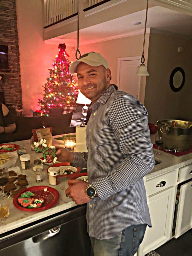 Joey holding up his decorated cookie in the kitchen.