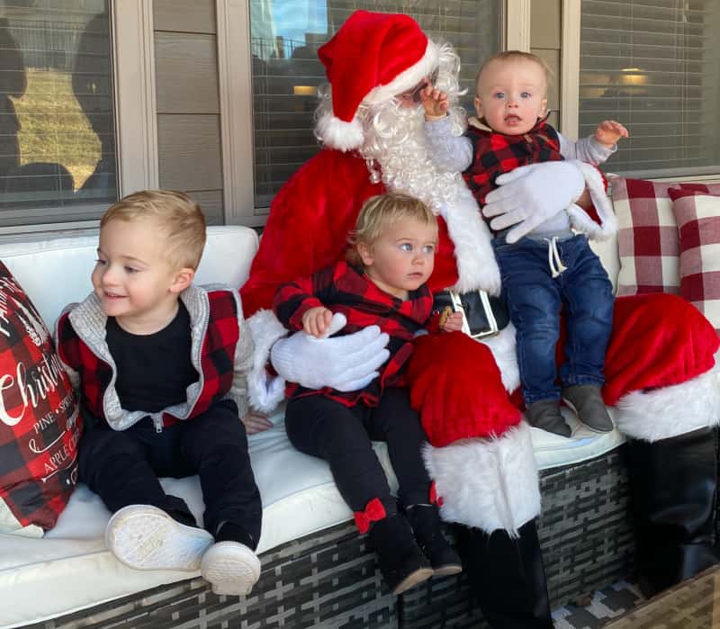 The babies sitting next to Santa