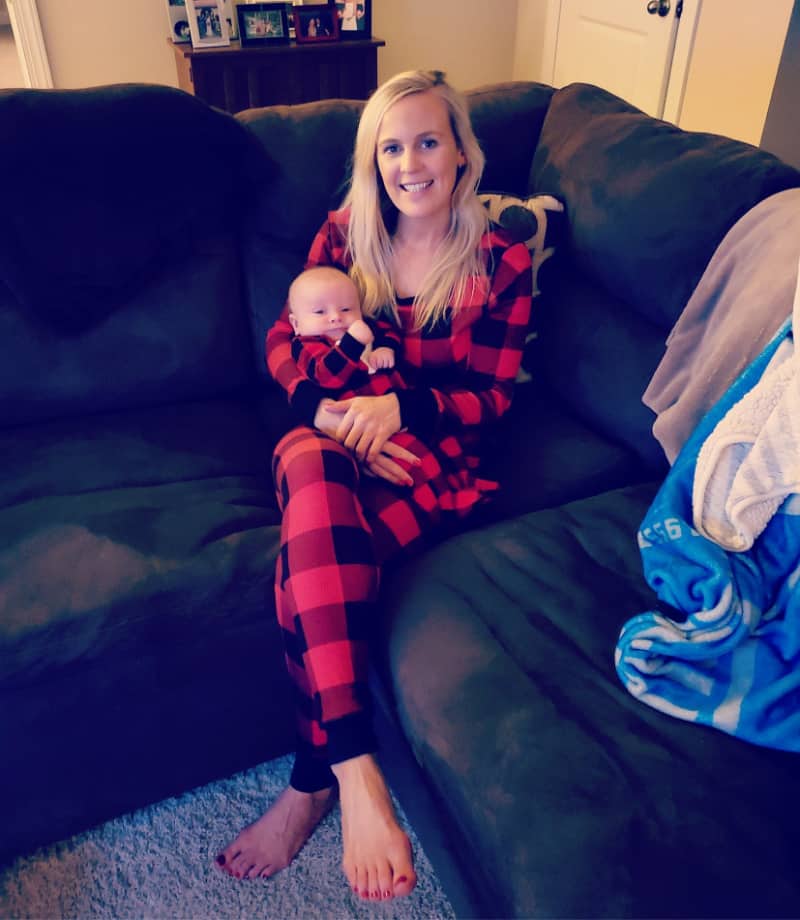 Lindsey holding Jacob on the couch in matching pajamas