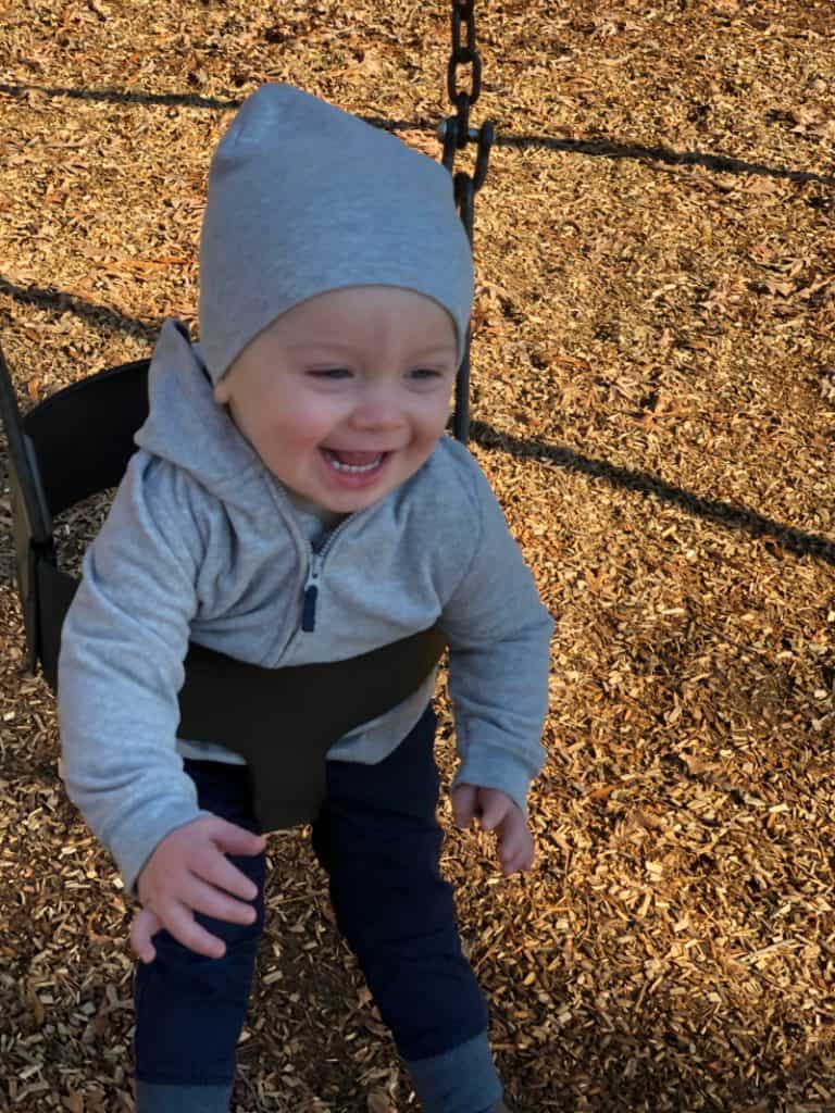 Jacob smiling on the swing