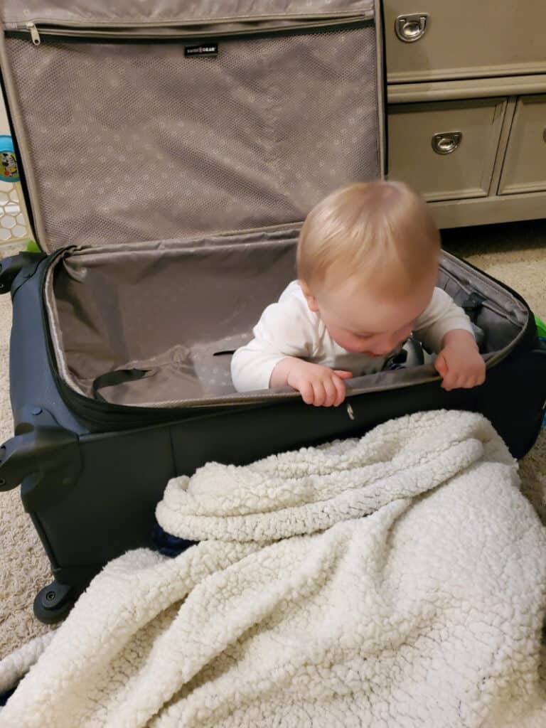 Jacob sitting in the suitcase at home